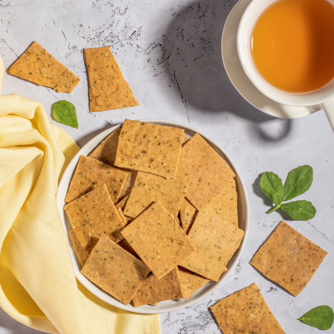 A bowl of fenugreek crackers and a cup of tea