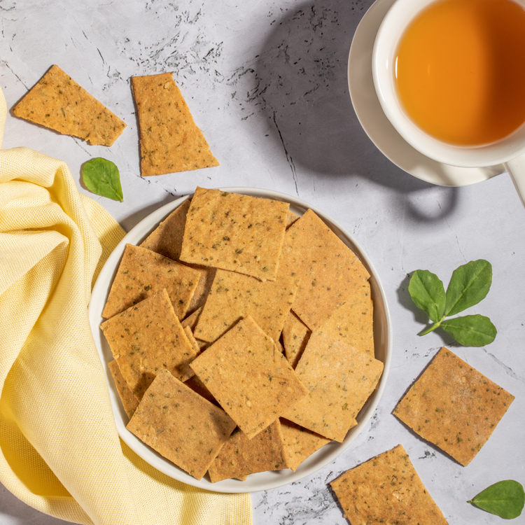 A bowl of fenugreek crackers and a cup of tea