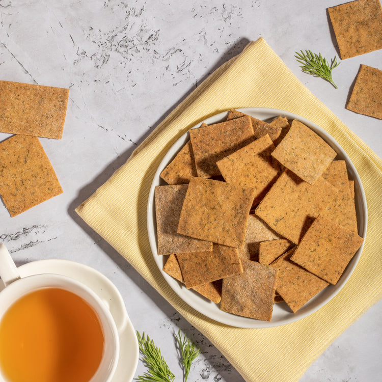 Artisanal dill crackers in a rustic wooden bowl, perfect for a healthy and flavorful snack option.