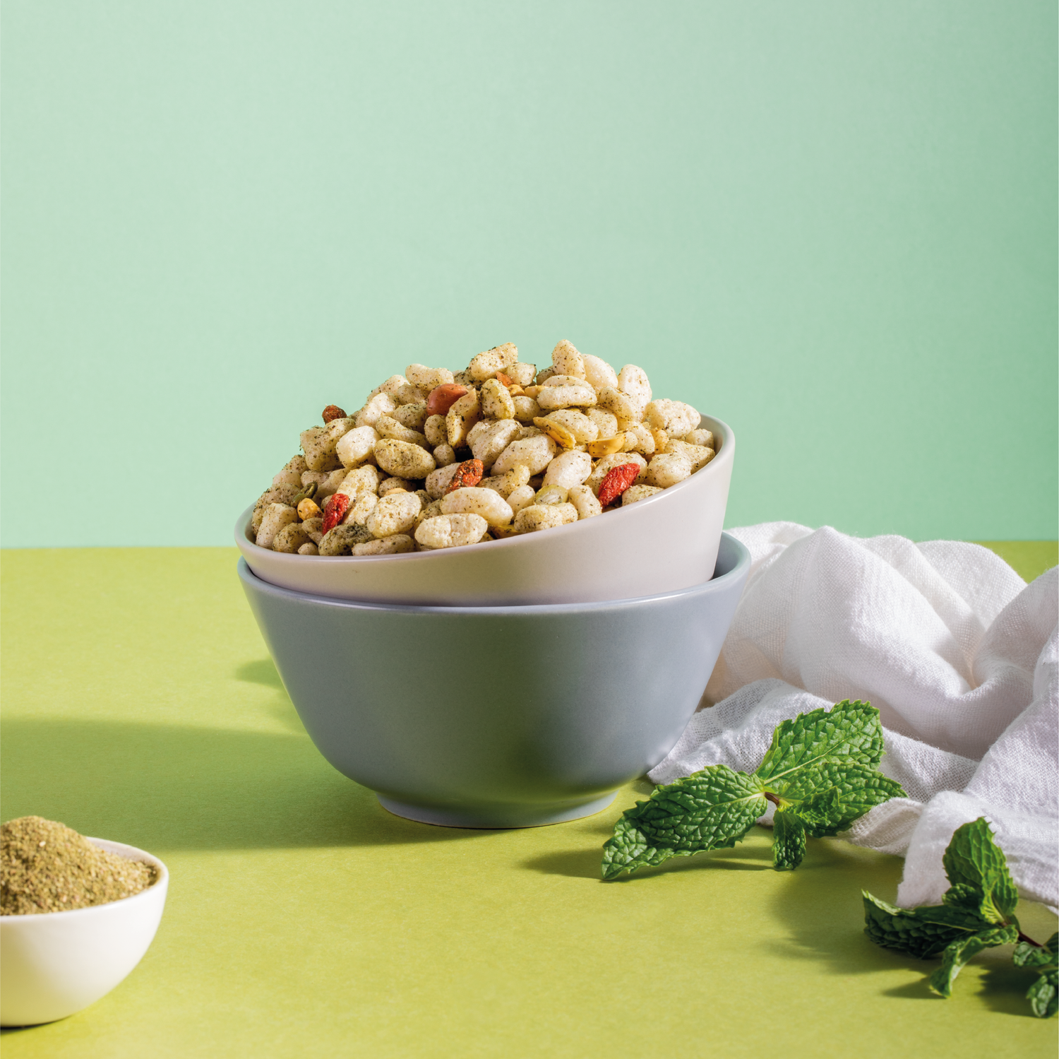 Mint Bhel in a bowl with Mint leaves around it