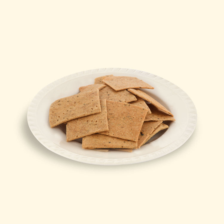 Crispy & Healthy cumin crackers in a rustic wooden bowl, perfect for a healthy snack at work, home, or on-the-go.