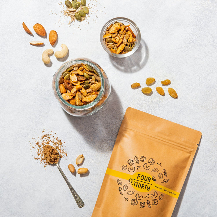 The image features Superseed Nutty Mix a mix of nuts and seeds in jars, with a brown "FOUR THIRTY" bag, perfect for healthy snacking.