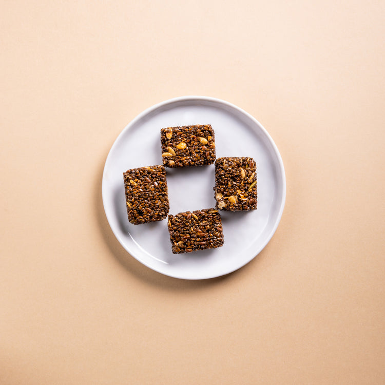 Black Sesame Superseed Crunch in a white plate on a table top