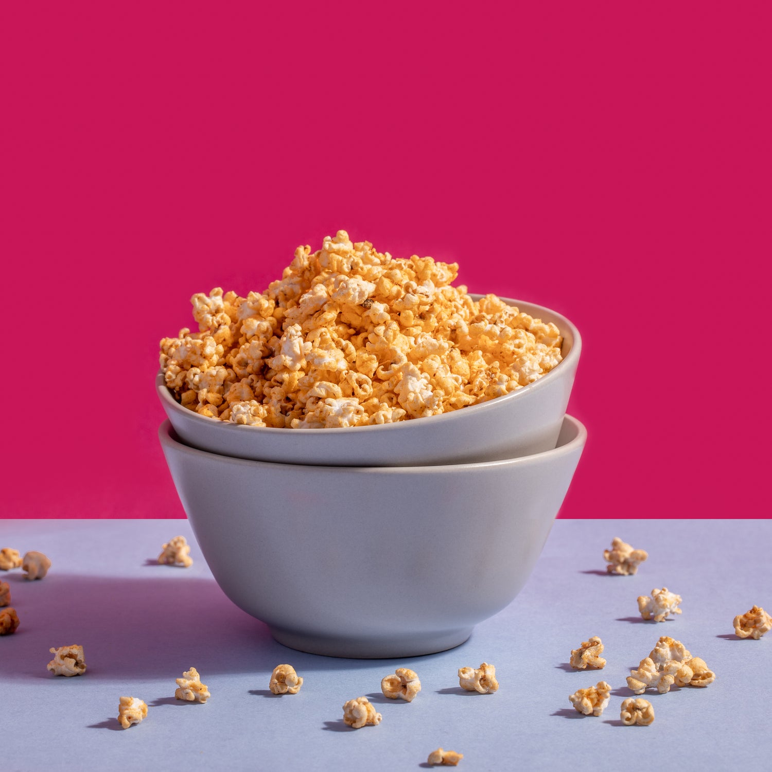 Masala pops in a white bowl against a pink background